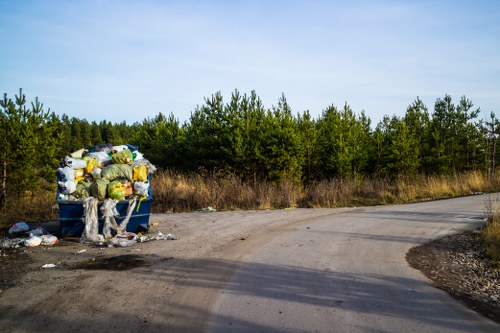 Construction site with debris being cleared by waste removal professionals